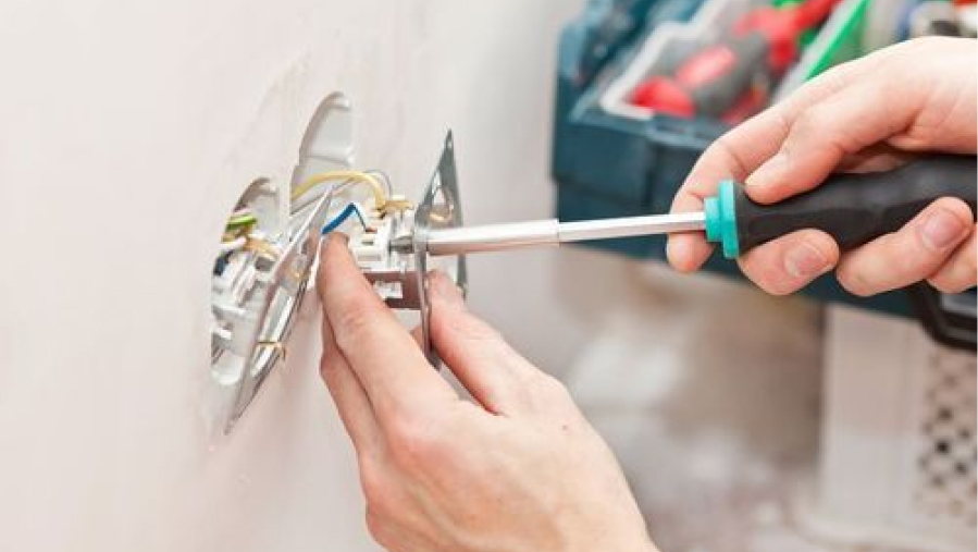 electrician fixing wiring in a retail store