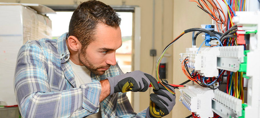 electrician in Washington DC repairs a breaker box